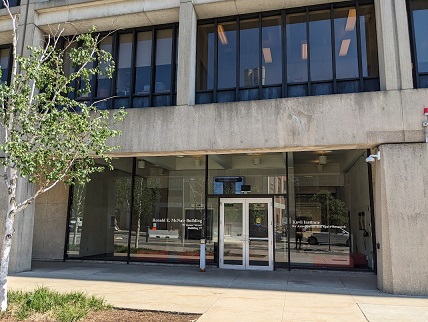 The facade of a building. Glass-walled doors are labeled McNair building.